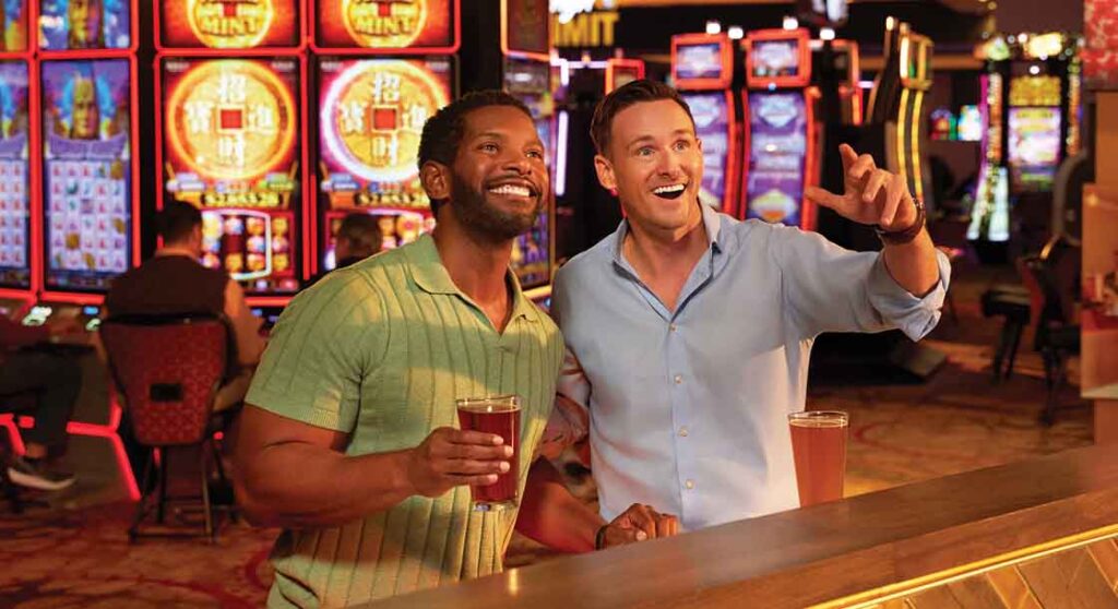 Two men watching the game at Sports & Stage bar